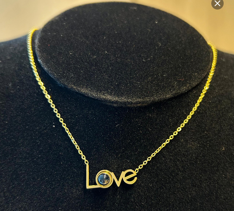 LOVE necklace with binoculars on the pendant.